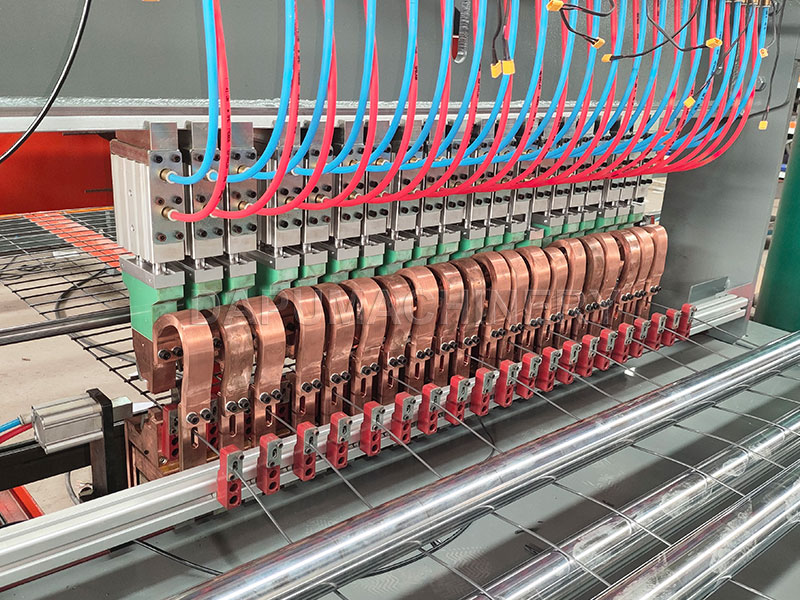 Detail of pneumatic welding cylinders and copper electrodes on JIAKE poultry chicken cage mesh welding machine